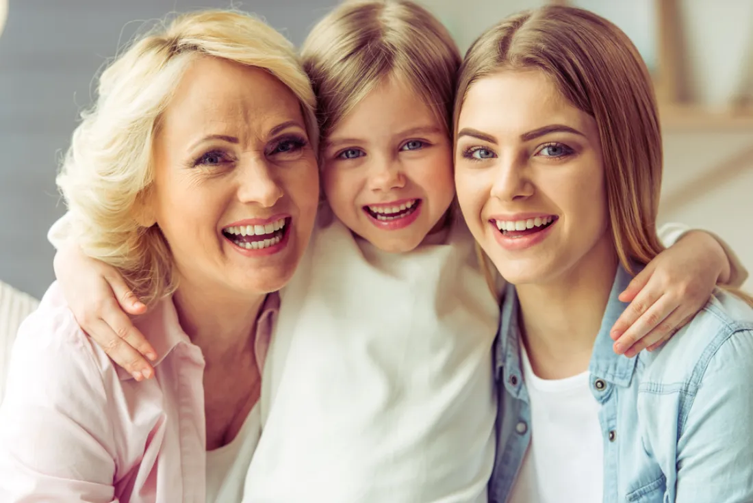 Three generations of a family smiling together